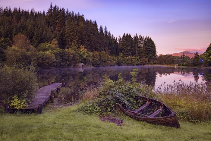 Old boat by a lake in Loch Ard Trossachs National Park, Scotland