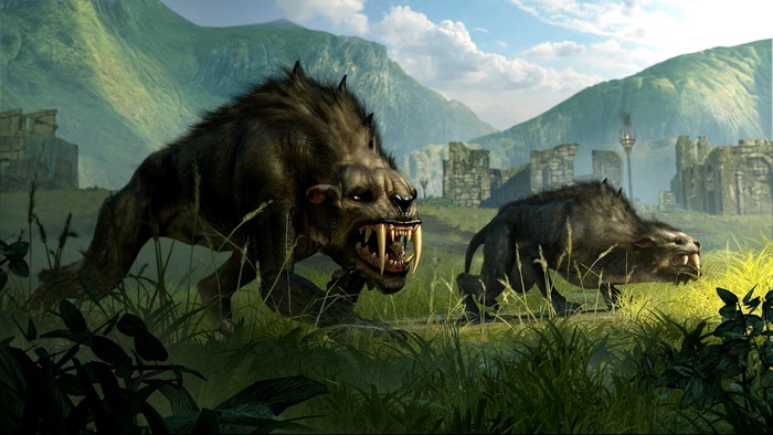 Two monsters with fangs in a grassy field