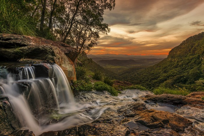 Waterfall over rocks at sunset in Queensland, Australia
