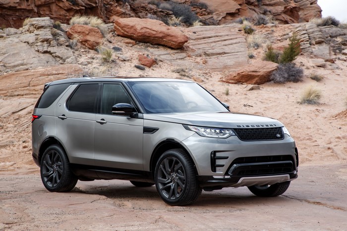 Silver Land Rover Discovery SUV in desert landscape