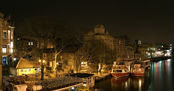 Riverboats docked at night in York, England