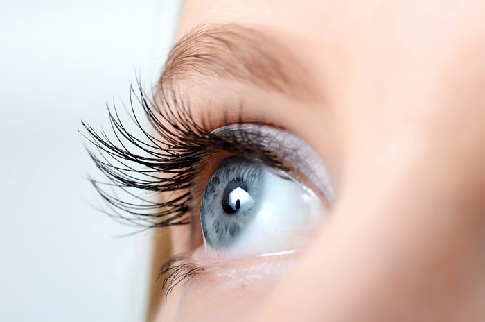 Macro closeup of a blue eye with long eyelashes
