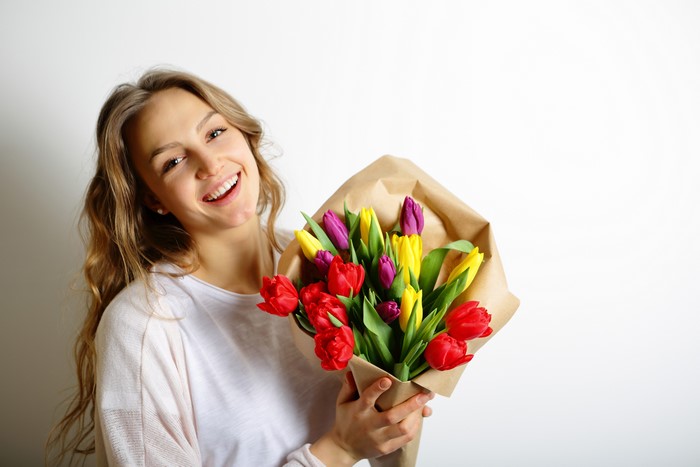 Blonde girl with a bouquet of tulips