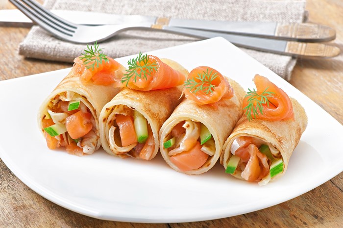 Pancakes with salmon and dill on a plate