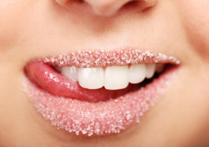 Lips covered in sugar with tongue and teeth
