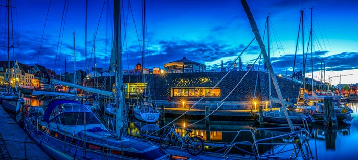 Boats docked in a marina at dusk in Stralsund, Germany