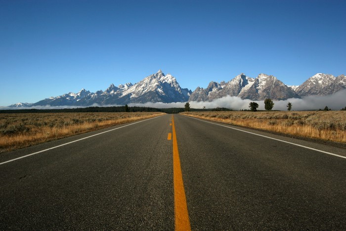 Road leading to snow-capped mountains