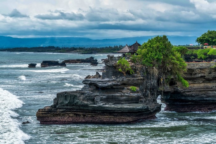 Tanah Lot Temple on rocky coast in Bali, Indonesia