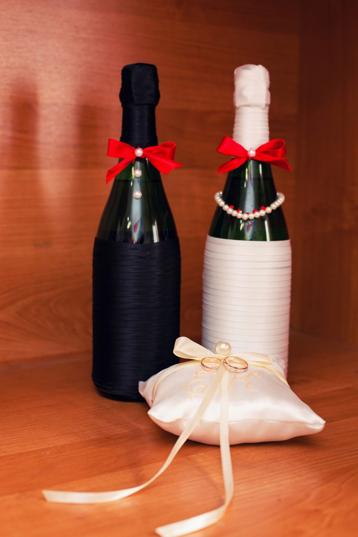 Wedding champagne bottles and ring pillow