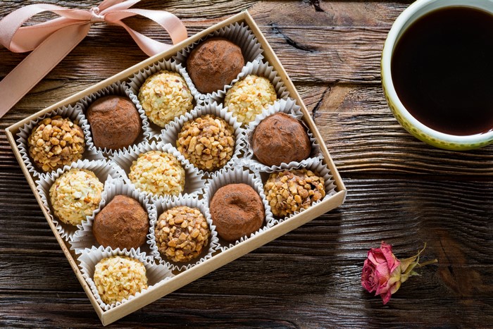 Box of assorted chocolates with coffee and rose