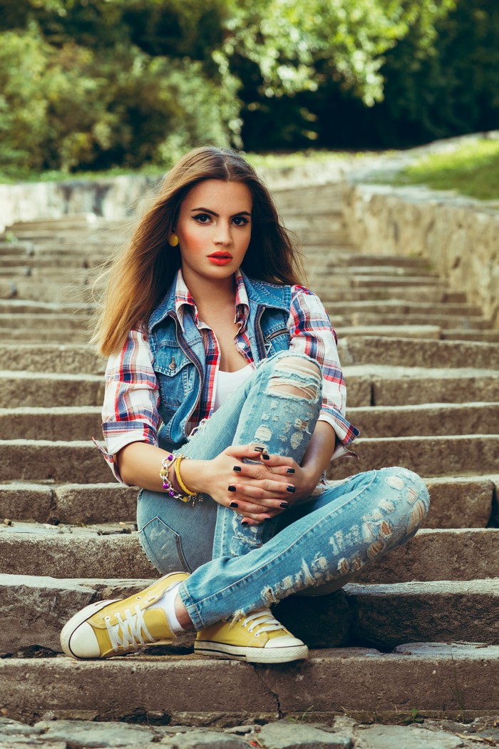 Woman sitting on stone stairs