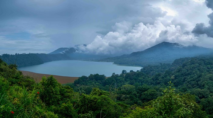 Lake surrounded by mountains and forests in Bali, Indonesia