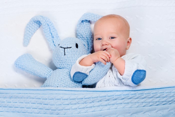 Baby with a blue bunny toy