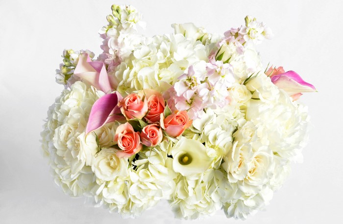 White and pink floral arrangement with roses and callas