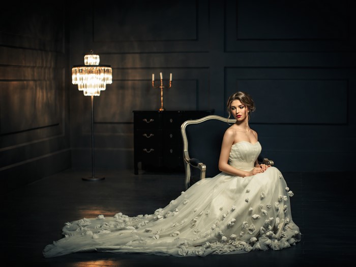 Woman in a wedding dress sitting in a chair