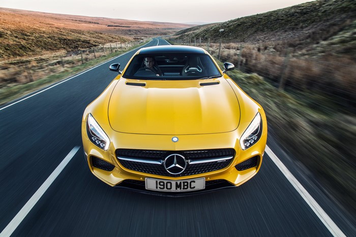 Yellow Mercedes-Benz AMG GT S driving on a road