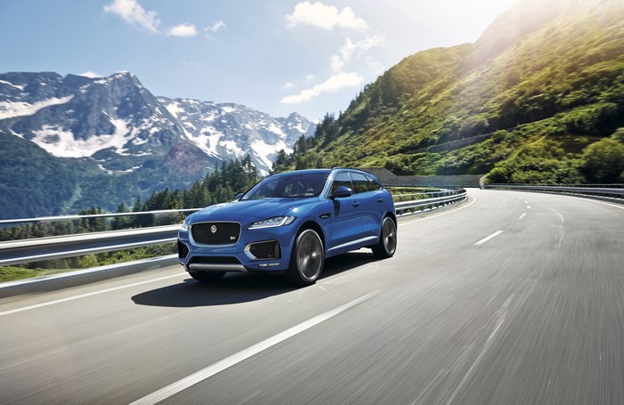 Blue Jaguar F-Pace S driving on a mountain road
