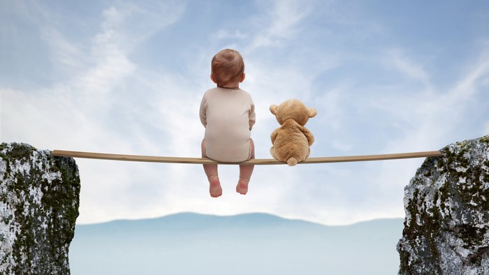 Baby and Teddy Bear on a Tightrope