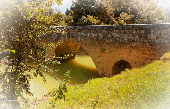 Stone bridge over a river in Aquitaine, France