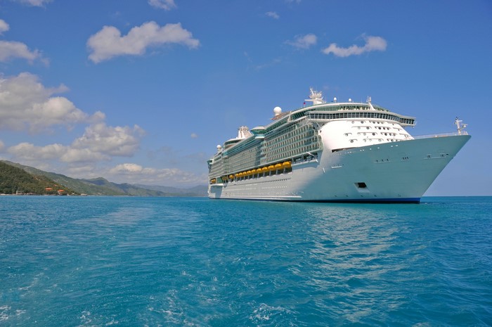 Cruise liner sailing on the ocean near a coastline