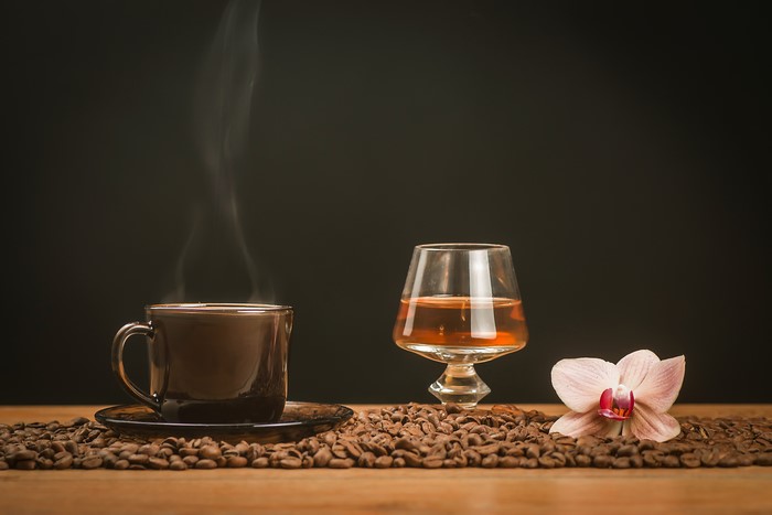 Still-life of coffee, alcoholic drink, and orchid