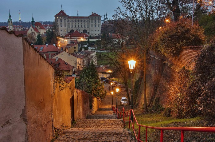 Cobblestone stairs with street lights in Prague at dusk