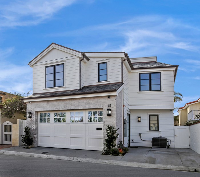 Modern white house with garage and blue sky