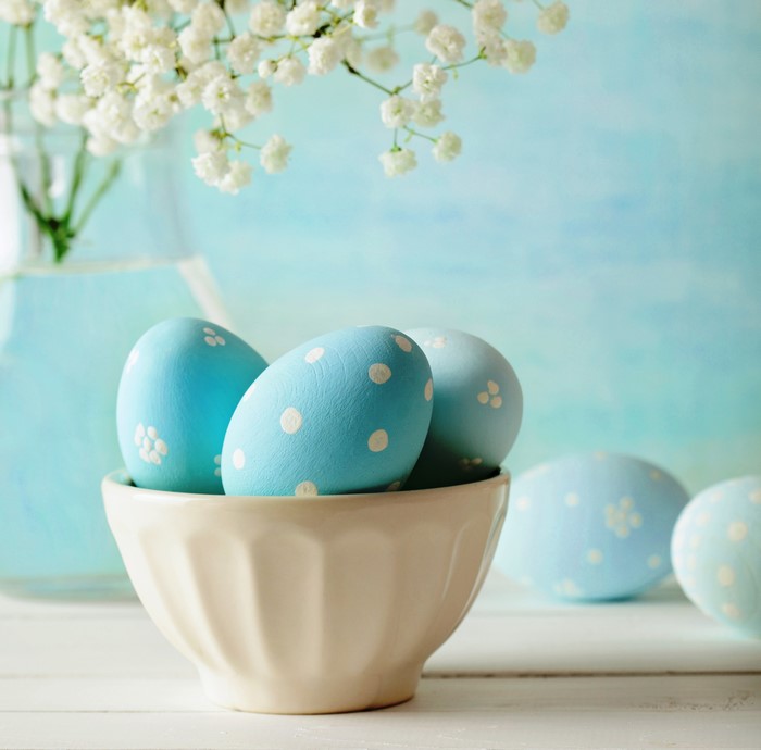 Easter eggs in a bowl with flowers