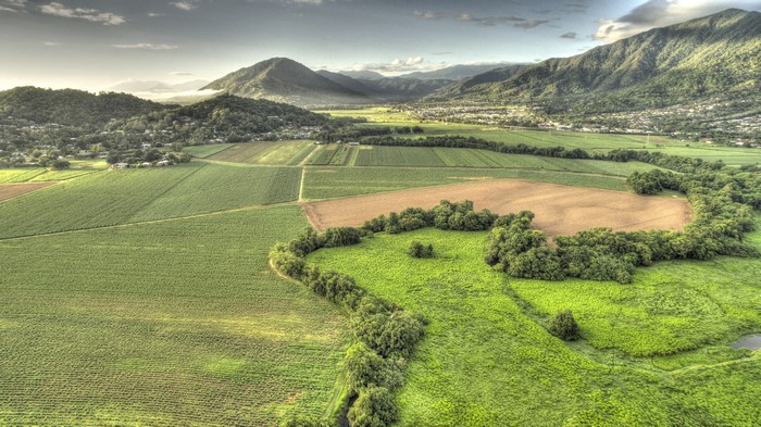 Aerial view of agricultural fields and hills in Barron, Queensland, Australia
