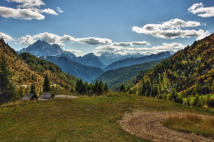 Mountain Valley with Spruce Trees and Clouds in Veneto, Italy