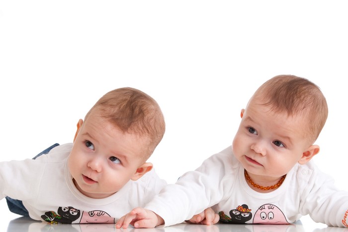 Two infants on a white background