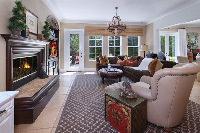 Living room with fireplace, sofa, and armchair