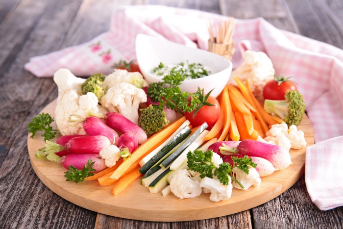 Vegetable platter with dip on a wooden board
