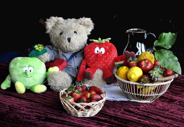 Still-life with teddy bear, fruit, and toys