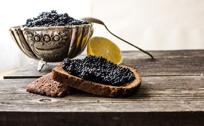 4K Caviar on Bread with Lemon and Spoon