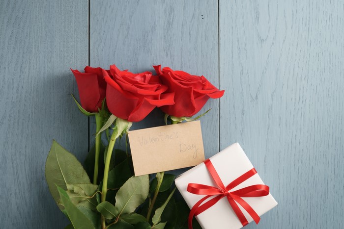 Red Roses, Gift, and Valentine's Day Card on Wood