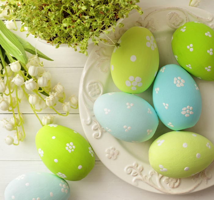 Easter eggs and lilies of the valley on a plate
