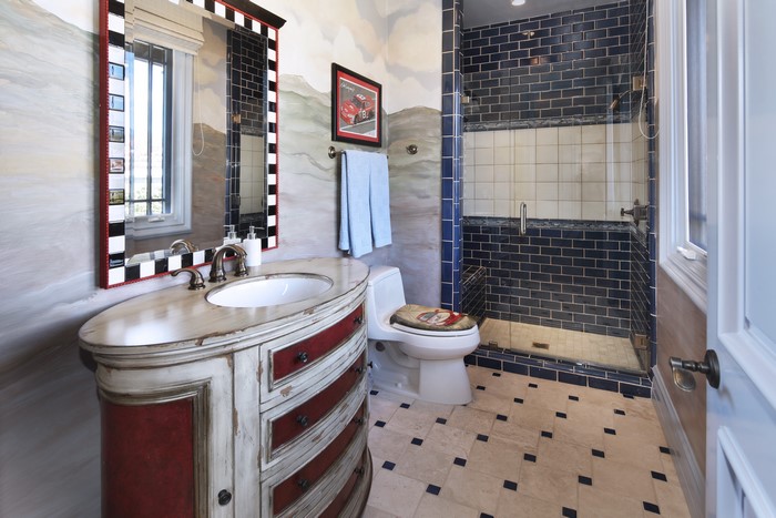 Bathroom with a vanity, toilet, and shower