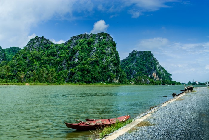 Vietnam mountains and river with a boat and buffalo