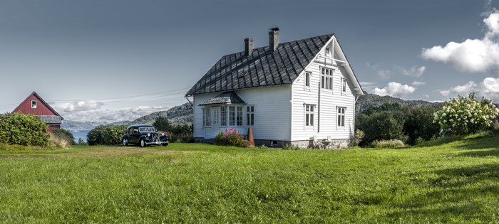 White house and red barn in Litla Hordaland, Norway