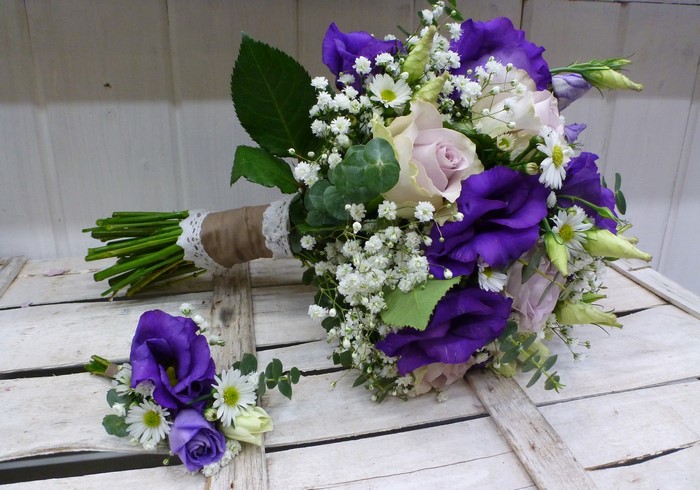 Purple and pink floral bouquet with boutonniere