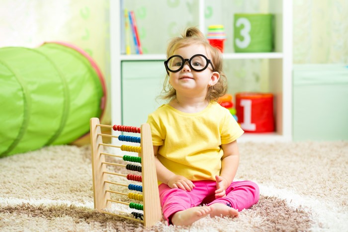 Little girl with glasses and abacus