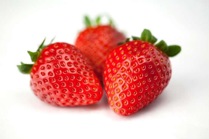 Three strawberries on a white background