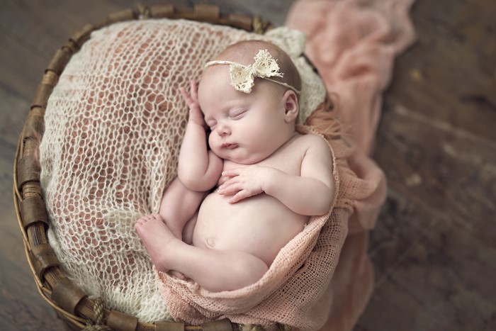 Newborn baby sleeping in a basket