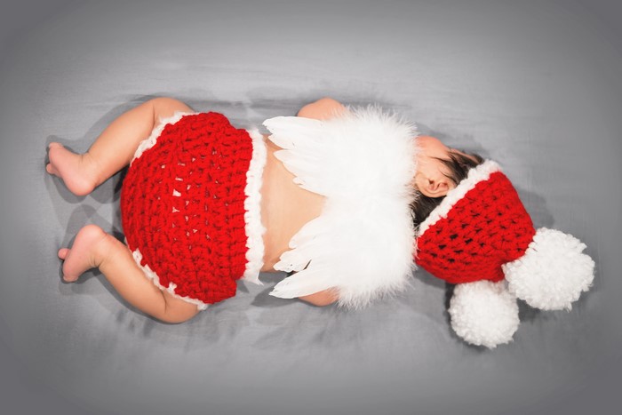 Baby in Santa costume with angel wings