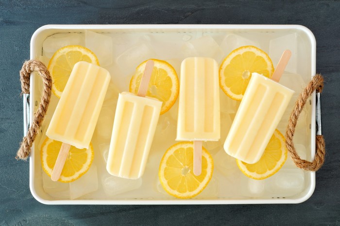 Lemon popsicles with lemon slices on ice