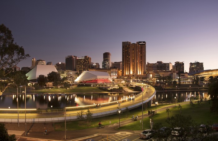 Adelaide skyline with river and bridge at dusk