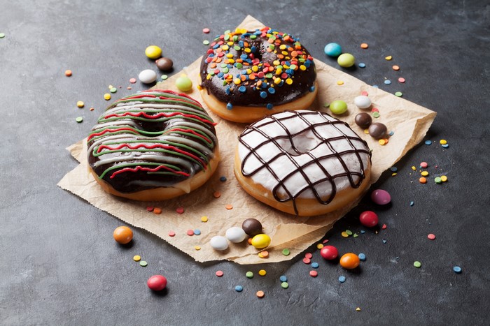 Three donuts with chocolate and icing sugar
