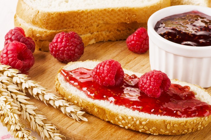 Bread with raspberry jam and raspberries