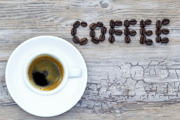 Coffee cup and word COFFEE made of coffee beans